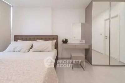 Modern minimalist bedroom with mirrored wardrobe and cozy bed