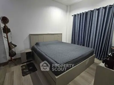 Modern bedroom with sleek design, featuring a comfortable bed and stylish curtains, perfect for relaxation.
