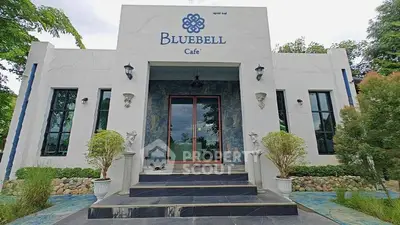 Charming cafe entrance with elegant design and lush greenery