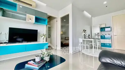 Modern living room with sleek furniture and vibrant blue accents in a stylish apartment.