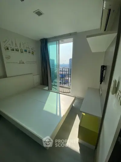 Modern bedroom with balcony view in high-rise apartment, featuring sleek design and ample natural light.