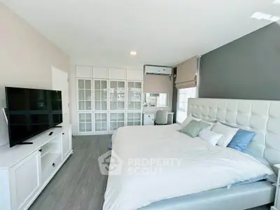 Spacious modern bedroom with large bed and stylish decor