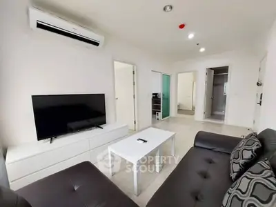 Modern living room with sleek furniture and air conditioning in a stylish apartment.