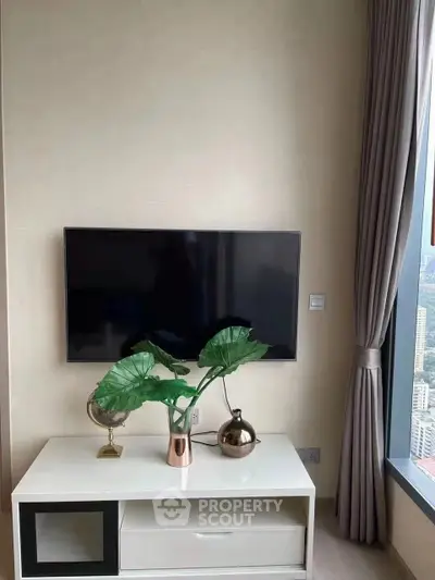 Modern living room with sleek TV setup and large window view