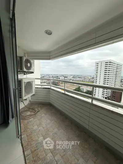 Spacious balcony with city view in modern high-rise apartment