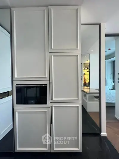 Modern kitchen with sleek cabinetry and built-in appliances in a stylish apartment.