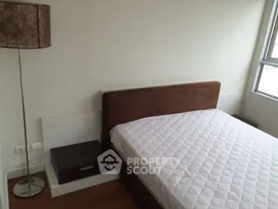 Modern bedroom with stylish lamp and large window for natural light