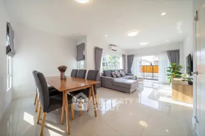 Spacious modern living room with dining area and large windows