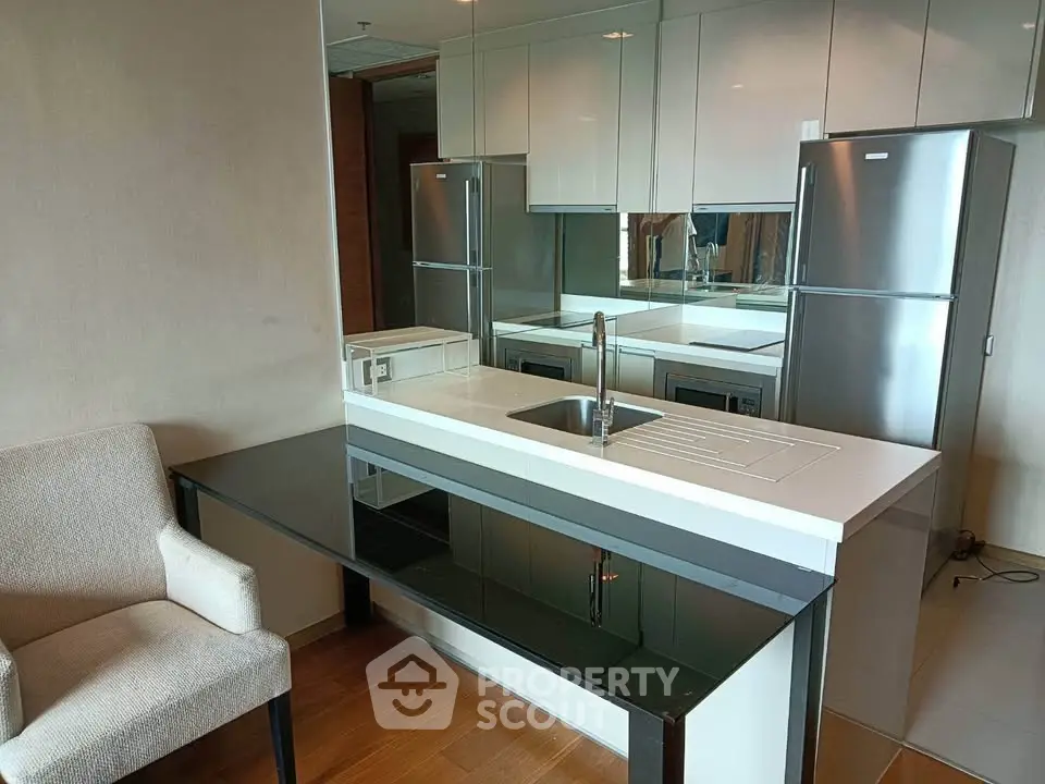 Modern kitchen with sleek design, featuring double fridge and elegant countertop.