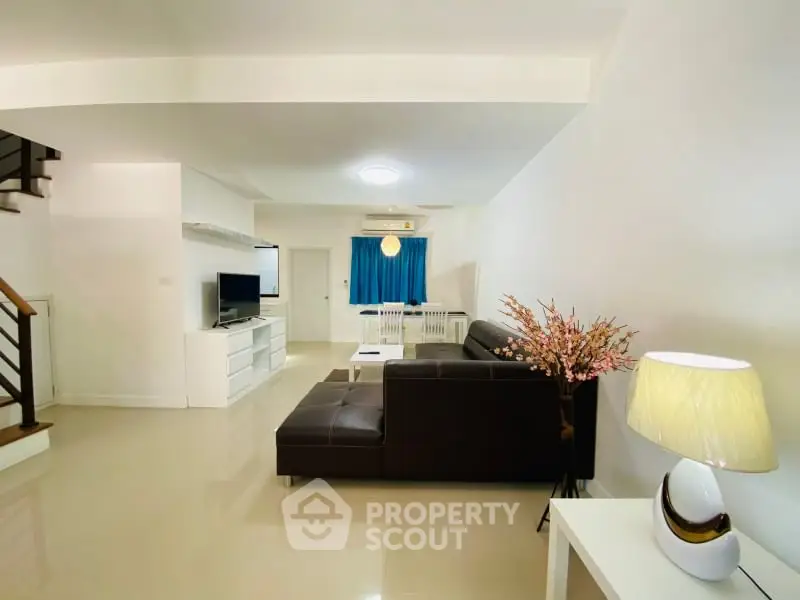 Spacious living room with modern decor and elegant lighting