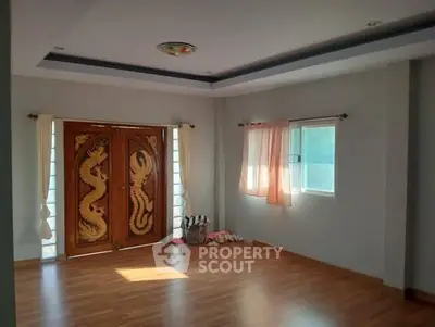 Spacious room with elegant wooden doors and natural light