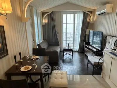 Charming living room with elegant decor and balcony view, perfect for cozy gatherings.