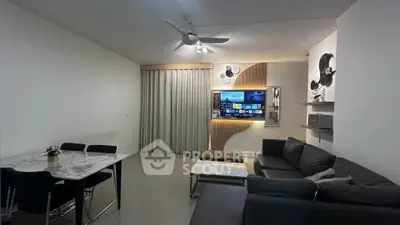 Modern living room with sleek furniture and wall-mounted TV, perfect for entertainment.