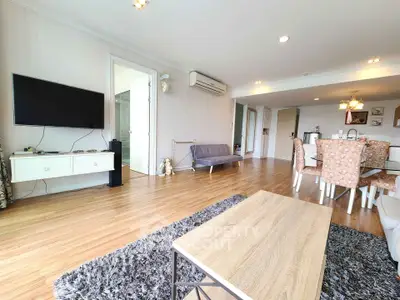 Spacious modern living room with wooden flooring and stylish furniture