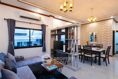 Modern living room with elegant dining area, featuring stylish lighting and contemporary decor.
