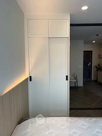 Modern bedroom with sleek wardrobe and cozy lighting