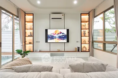 Luxurious modern living room with elegant decor and large windows offering natural light.