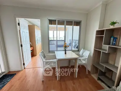 Charming dining area with natural light and balcony access in modern apartment.