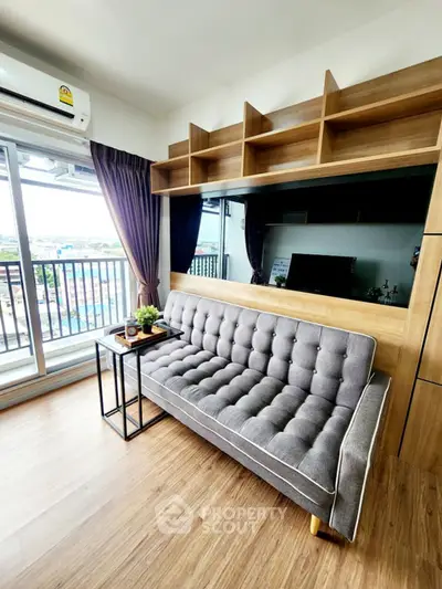 Modern living room with stylish sofa and balcony view