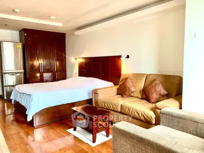 Spacious studio apartment with cozy living area and modern furnishings.