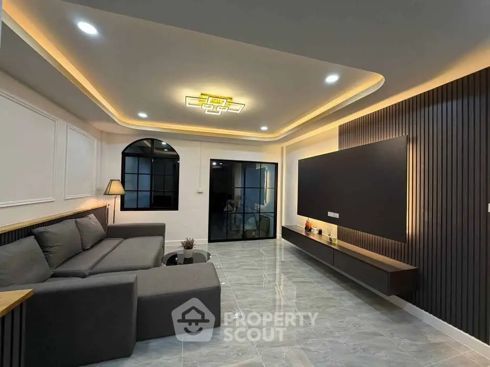Modern living room with sleek design, recessed lighting, and stylish furniture for a contemporary lifestyle.