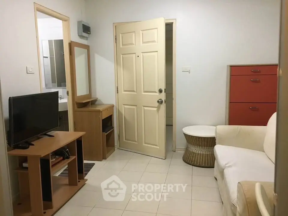 Cozy living room with TV and modern furniture in compact apartment