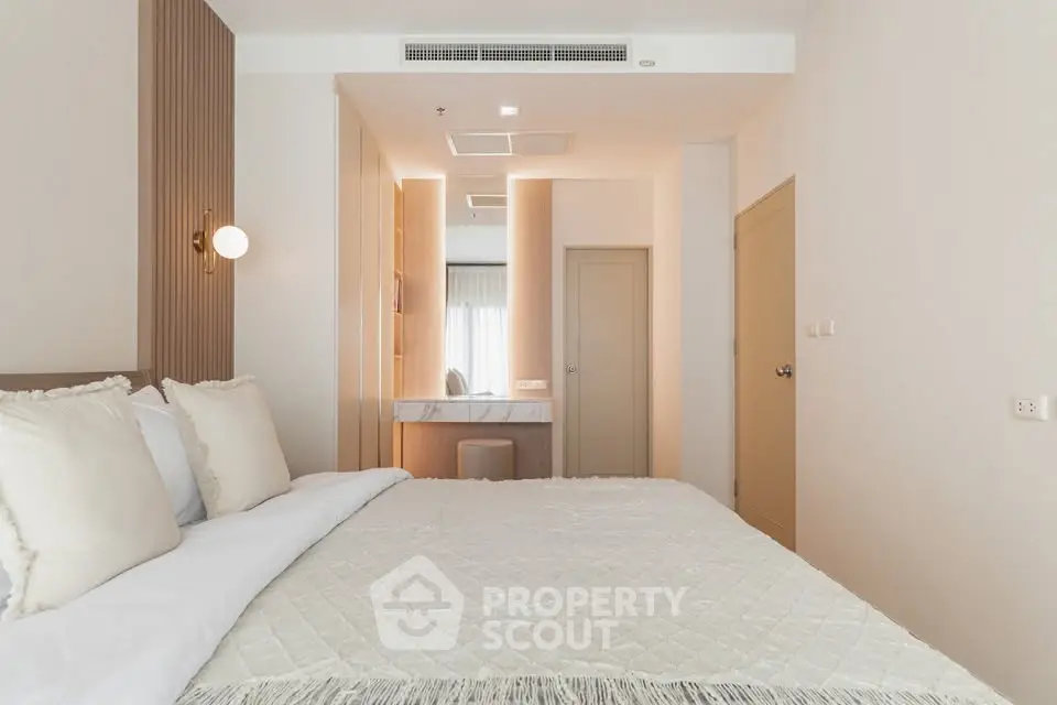 Modern bedroom with elegant decor and cozy ambiance in a stylish apartment.