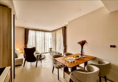 Elegant living room with modern furniture and large windows offering natural light.