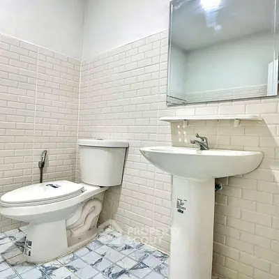 Modern bathroom with white subway tiles and pedestal sink