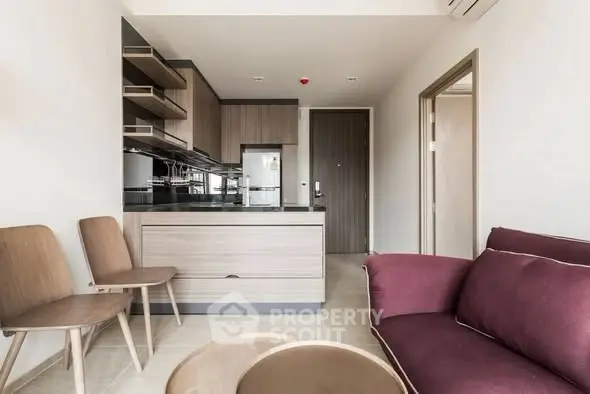 Modern open-layout kitchen and living area with stylish furniture.
