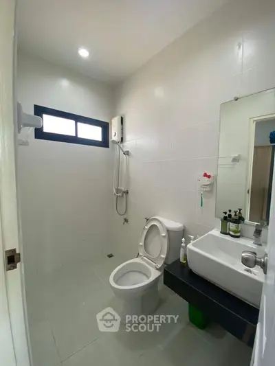 Modern bathroom with sleek fixtures and natural light, ideal for contemporary living.