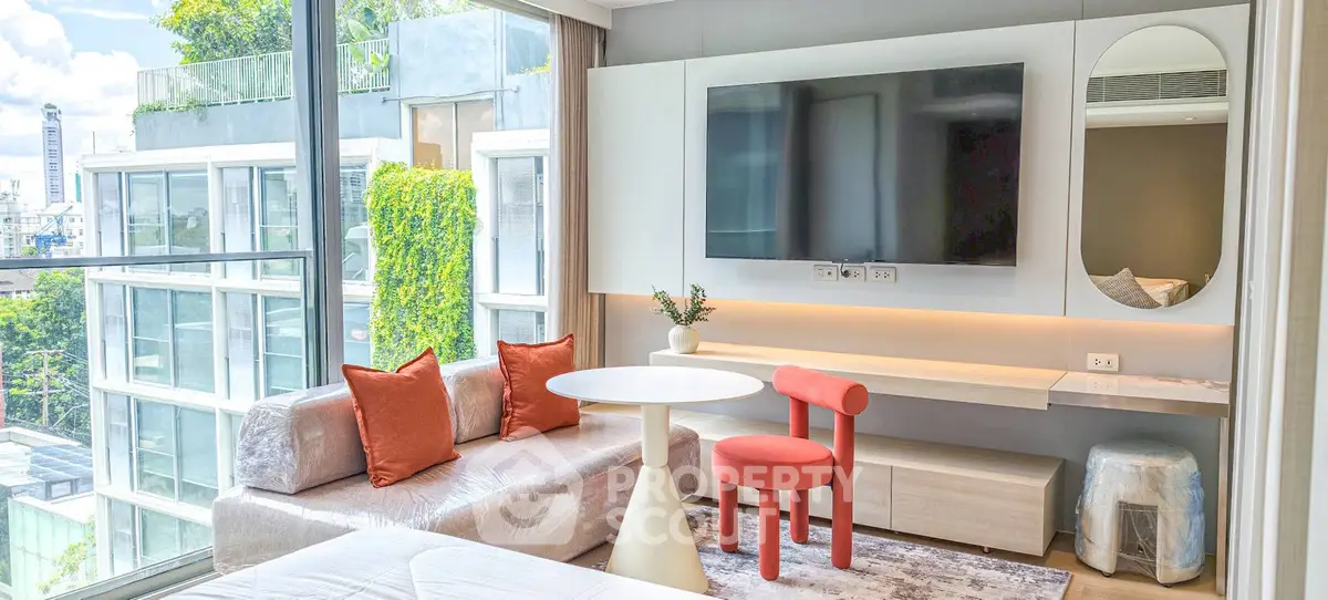 Modern living room with large window, stylish furniture, and city view in luxury apartment.