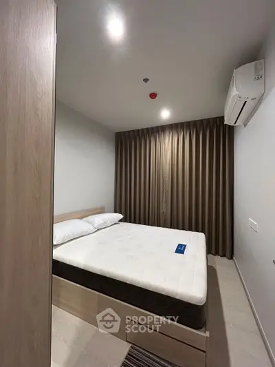 Cozy modern bedroom with air conditioning and elegant curtains