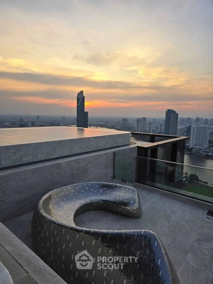 Stunning rooftop view with modern seating and city skyline at sunset