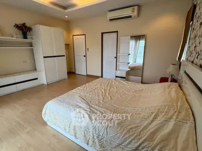 Spacious bedroom with modern furnishings and natural light