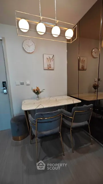 Stylish dining area with modern lighting and elegant decor in a contemporary apartment.