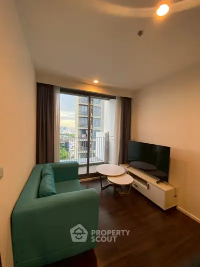 Cozy living room with modern furniture and balcony view in a high-rise apartment.