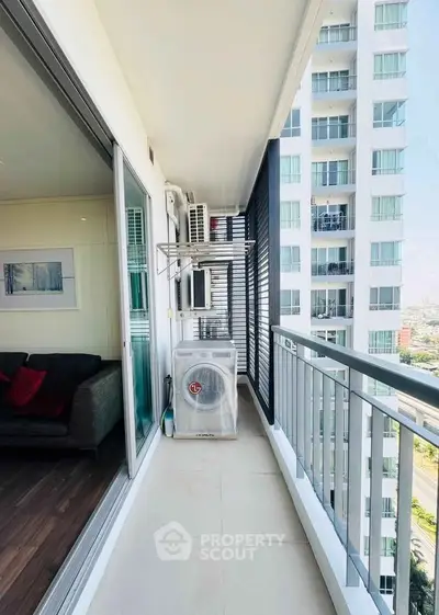 Modern balcony with city view in high-rise apartment, featuring sleek design and ample space for relaxation.