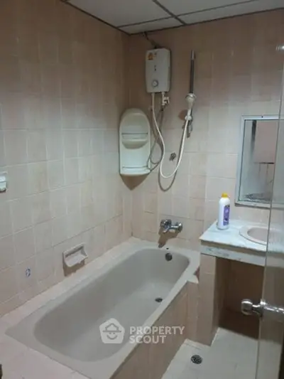 Cozy bathroom with bathtub and shower in a tiled setting