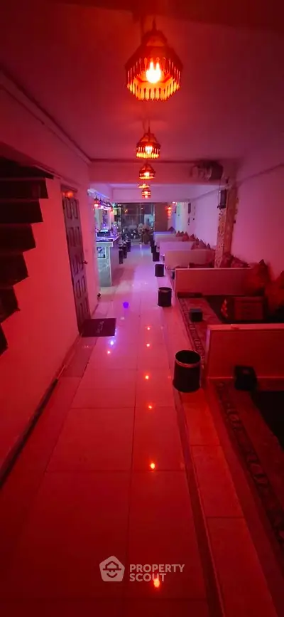 Chic and ambient hallway with modern lighting and cozy seating area