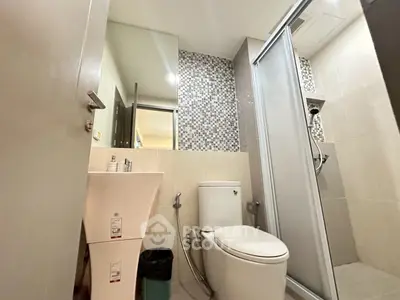 Modern bathroom with sleek fixtures and glass shower enclosure