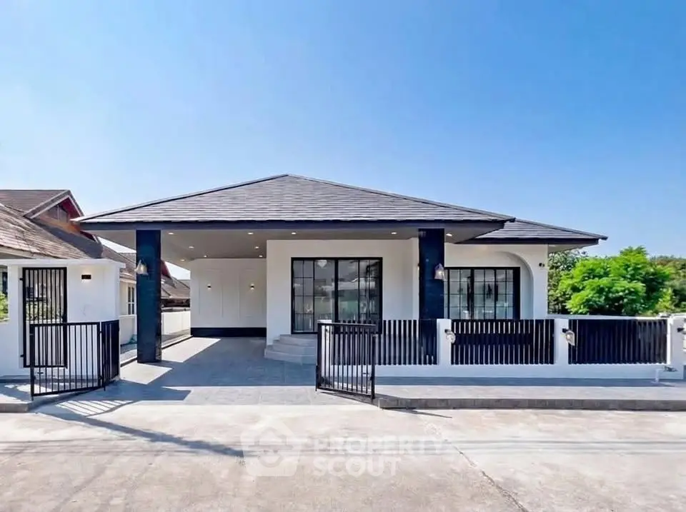 Modern single-story house with sleek design and spacious driveway in a serene neighborhood.