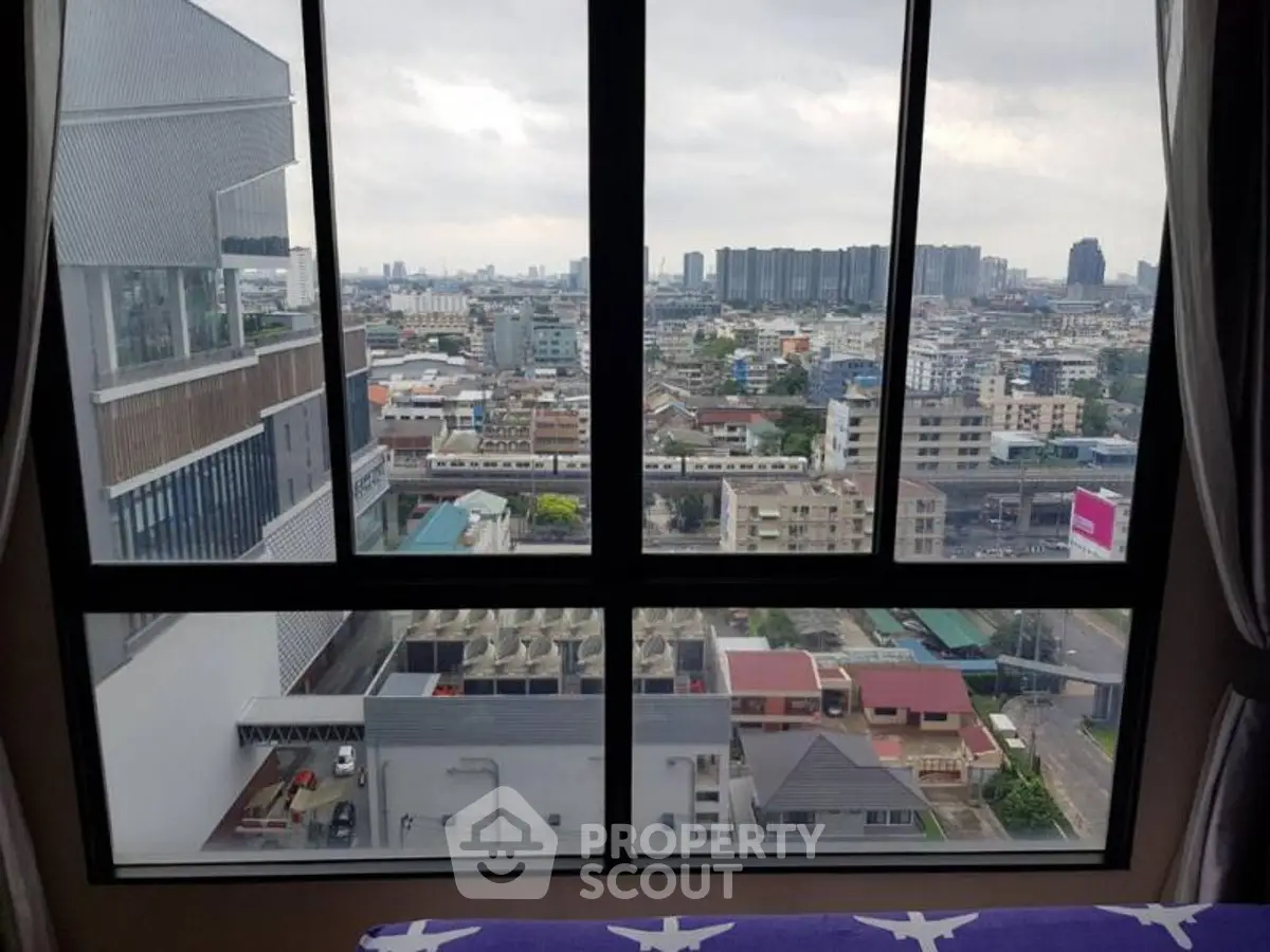 Stunning cityscape view from high-rise apartment window, showcasing urban skyline.