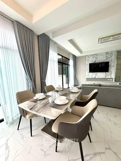 Luxurious modern dining area with marble table and elegant chairs, featuring floor-to-ceiling windows and stylish decor.