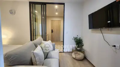 Modern living room with cozy sofa and wall-mounted TV in stylish apartment