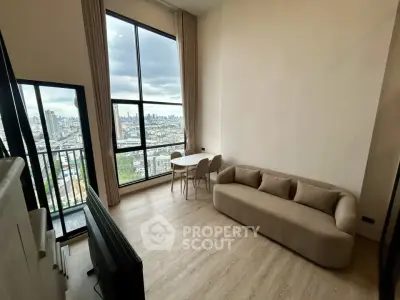 Modern living room with large windows and stunning city view, featuring a cozy sofa and dining area.