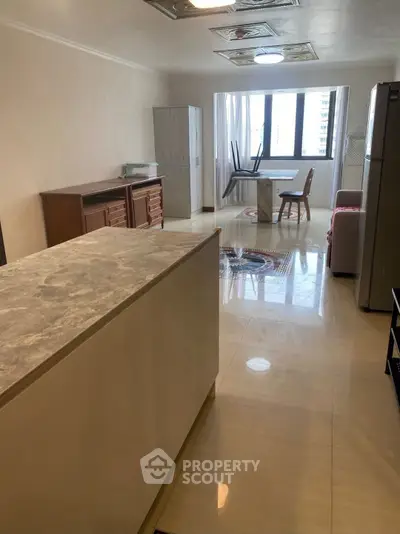 Spacious living room with modern furniture and large window view