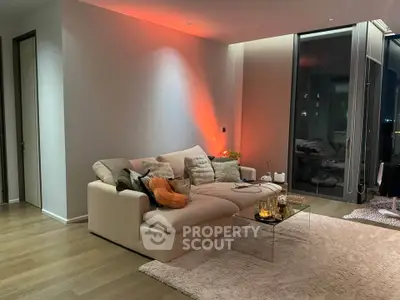 Modern living room with cozy sofa and ambient lighting