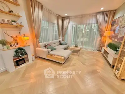 Elegant living room with modern decor, large windows, and cozy seating area in a stylish home.