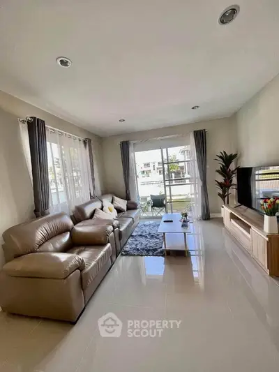 Spacious living room with modern decor and large windows offering natural light.